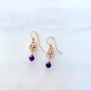 Gold earrings with deep purple stone drop